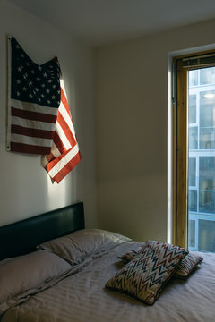 US Flag over a bed