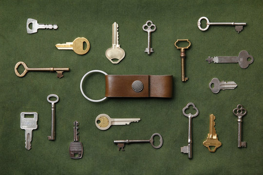 keys arranged around a key chain on green canvas fabric
