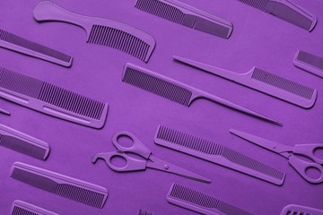 Various hairdresser tools in purple color on purple background.
