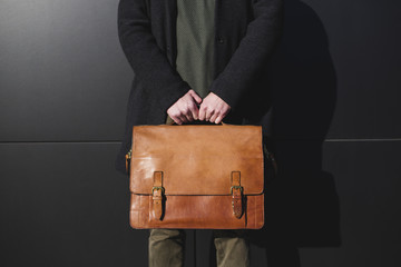 Male hands holding a briefcase