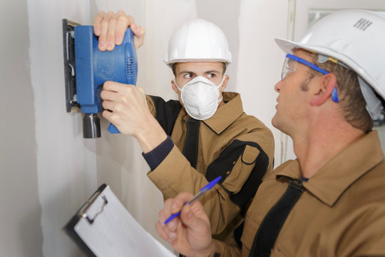 Plumbing Apprentice Installing A Line On The Wall