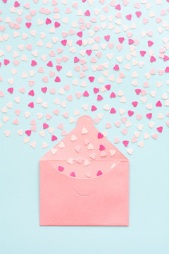 Exploding Pink Heart Confetti From Envelope On Blue Background