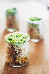 Salad in jars made with quinoa and vegetable cut in julienne form.