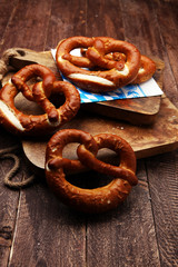 Pretzels on wooden board on rustic background. german food.