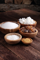 Fototapeta na wymiar Various types of sugar, brown sugar and white on wooden table