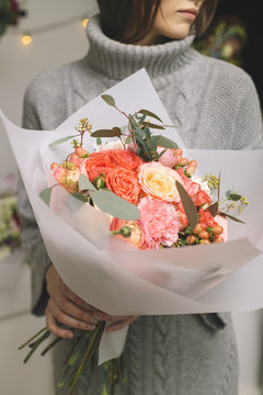 Woman holding beautiful bunch of pink flowers