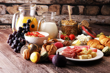 Breakfast served with coffee, orange juice, croissants, cereals and fruits. Balanced diet.