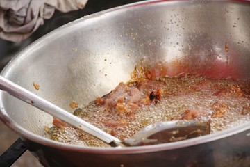 Fried pork in pan in street food