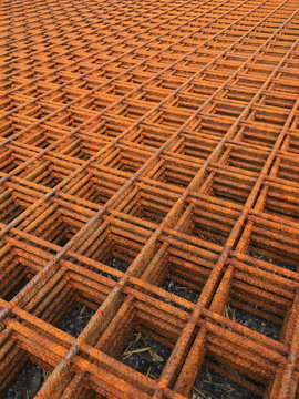 View on endless stack of rusty metal gratings