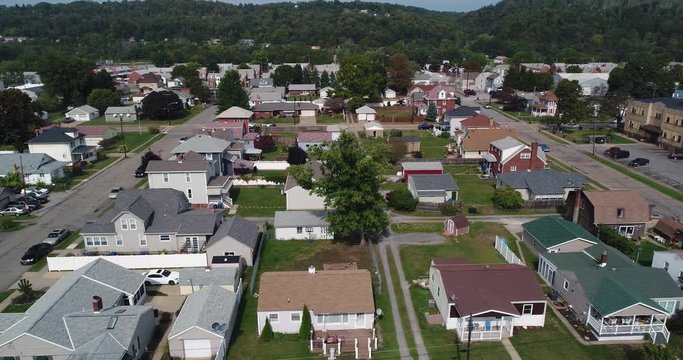 An aerial establishing shot of a typical Western Pennsylvania residential neighborhood in late summer. Pittsburgh suburbs.  	