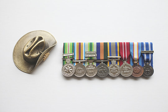 An Australian army khaki slouch hat with collection of service medals and medallions