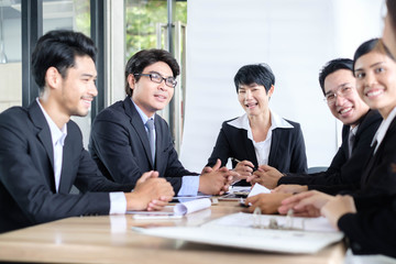 Asian business people meeting time,manager listening his staff brainstorming discussing about new startup project together in conference room at office,business colleagues teamwork concept