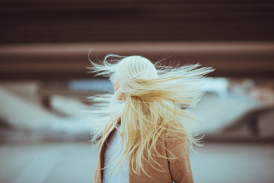 Young woman lets her hair flow in the wind