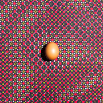 Single egg against a vibrant patterned background.