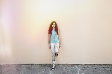 Pre-teenager girl standing in front of a wall