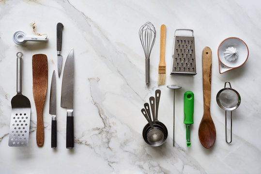Different kitchenware tools on marble table