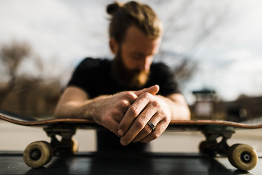 Man leaning on skateboard