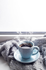 cozy soft gray blanket with a cup of coffee