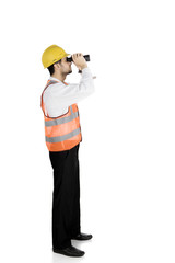 Young foreman using a binocular on studio