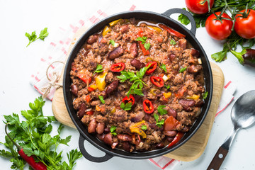 Chili con carne. Traditional mexican food. Top view on white.