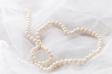 Pearl necklace on white veil
