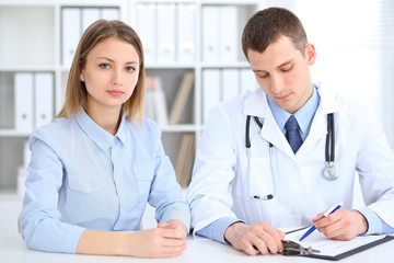 Doctor and  patient  sitting at the desk. Medicine and health care concept