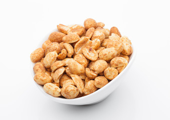 Salty peanuts snack in white bowl