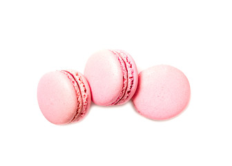 Three pink macaroon cookies isolated on white background