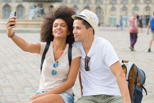 tourist couple taking selfies