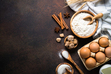 Ingredients for cooking baking. Top view with copy space on dark rusty table.