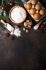 Fototapeta na wymiar Ingredients for cooking christmas baking. Top view on dark stone table.