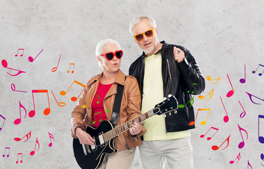 senior couple in sunglasses with electric guitar