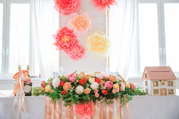flowers on the table in bright hall with little hlouse