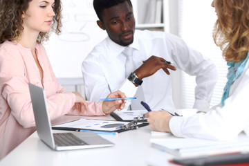 Obraz premium African american businessman at meeting in office, colored in white. Negotiation or hard decision concept