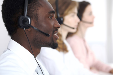 African american call operator in headset. Call center business or customer service concept