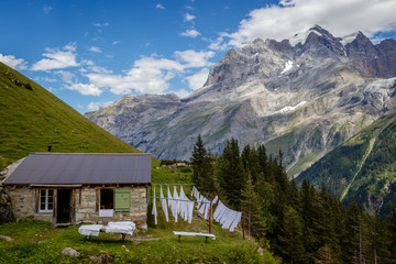 Clean crisp white sheets drying in the sun in the beautiful Lauterbrunnen valley which is a UNESCO world heritage  