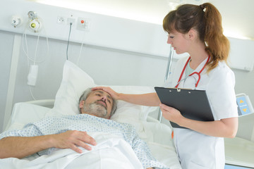 Obraz premium touching the patient's forehead