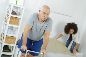 old senior man with walker in a nursing home
