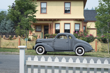 Victorian house with old car