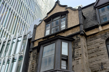 Old and new houses with huge windows in Montreal downtown, Canada.