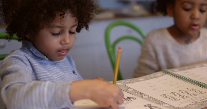 Two Children Doing Homework At Kitchen Table Shot On R3D