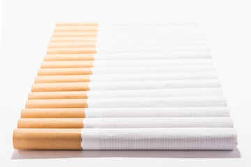 cigarettes lined in a row, perspective view, on a white background