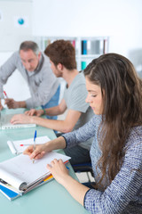 Fototapeta premium Students taking notes while teacher is talking