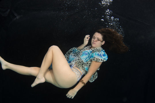 Woman wearing a swimsuit underwater.