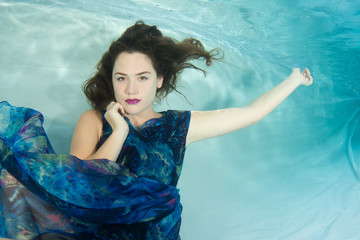 Women wearing a print dress in a pool.