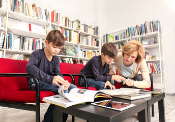 Teacher and children at school library