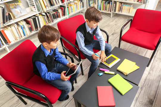 Children studying at school library