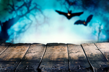 Wooden boards with bats in background