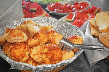 Bowl with delicious cheese buns in buffet