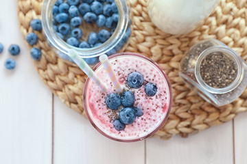 Smoothie with chia seeds in glass on table